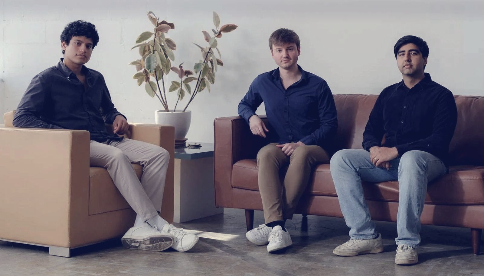Mercor co-founders Adarsh Hiremath, Brendan Foody and Surya Midha seated together in a studio portrait