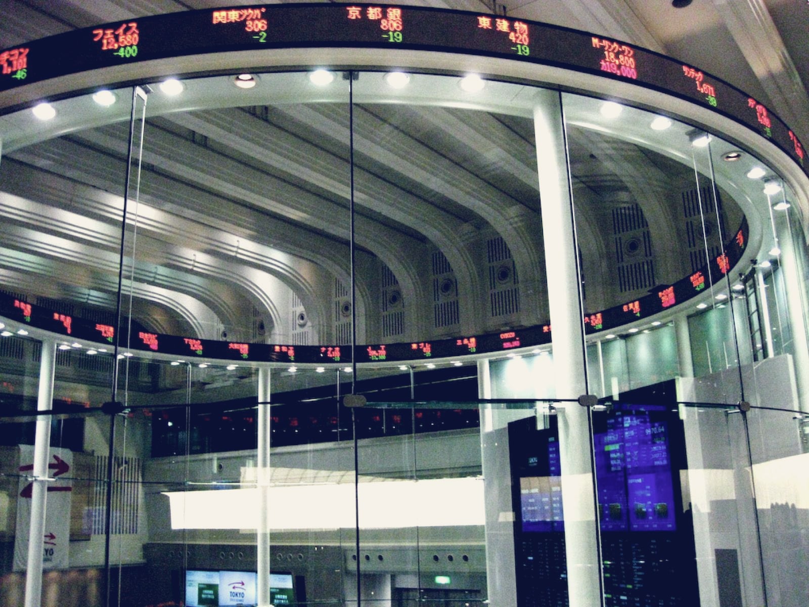 The market centre at the Tokyo Stock Exchange, a glass cylinder and a few screens where a trading floor used to be (context image, not the subject)