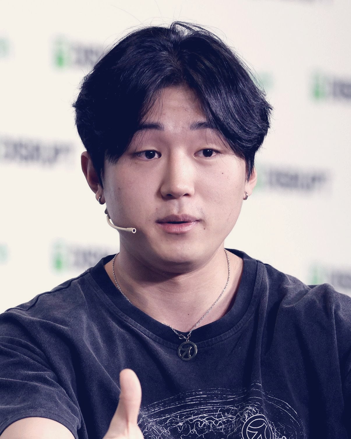 Roy Lee, co-founder and CEO of Cluely, gesturing as he speaks on a TechCrunch Disrupt stage.