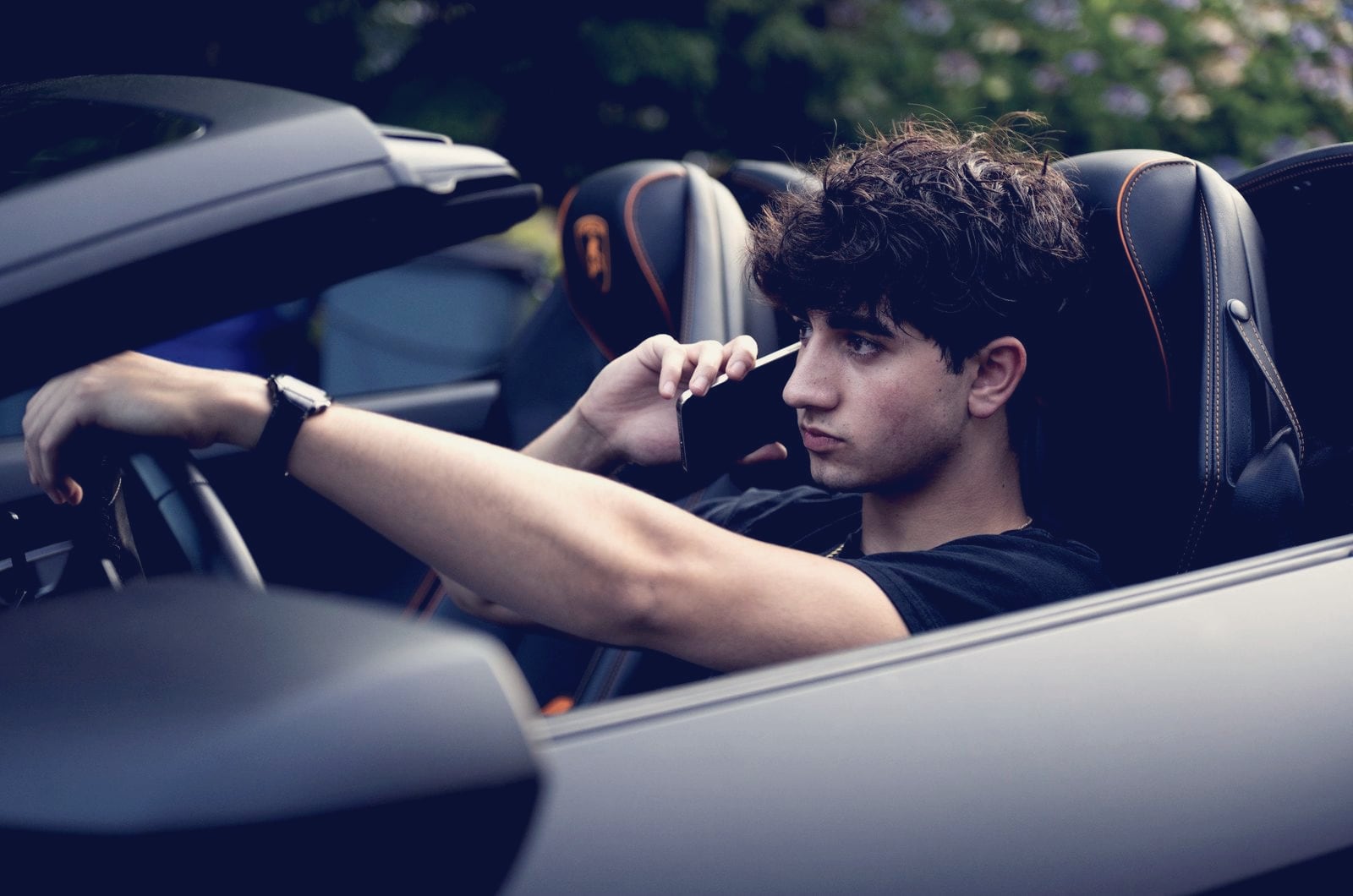 Zach Yadegari, Cal AI co-founder, on a call in the driver's seat of a convertible in a 2025 Fortune profile